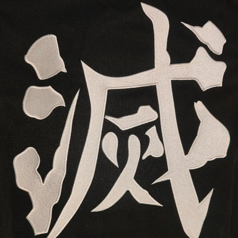 Tanjiro Kamado cosplay haori embroidered kanji detail from Demon Slayer Kimetsu no Yaiba